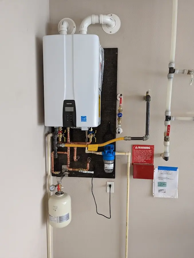 Professional plumber installing copper piping in a San Leon home